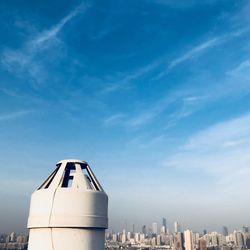 View of cityscape against cloudy sky