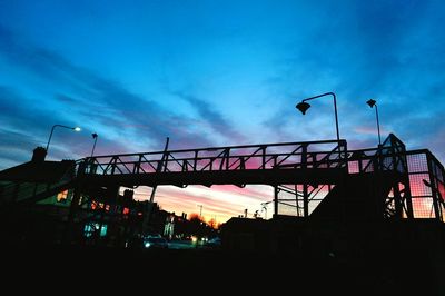 Low angle view of silhouette bridge against sky at sunset