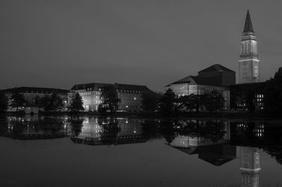 Reflection of illuminated buildings in lake at night