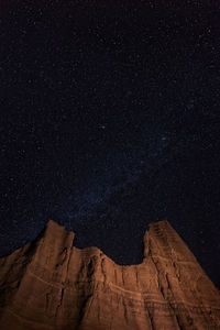 Low angle view of rock formations against sky at night