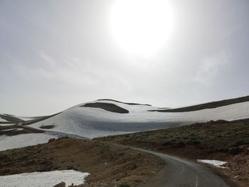 Scenic view of snow covered mountain against sky