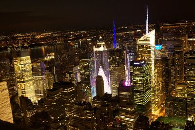 High angle view of city lit up at night