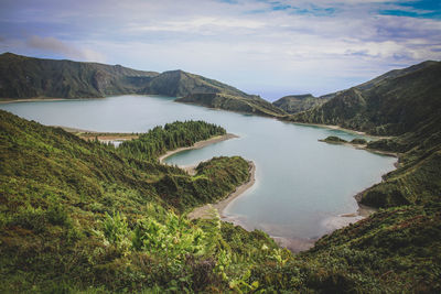 Scenic view of lake and mountains against sky