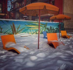 Close-up of chairs on sand