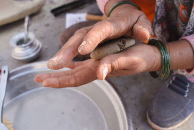 High angle view of woman making dough balls