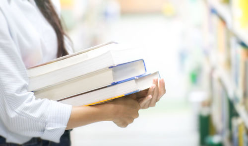 Close-up of hand holding book