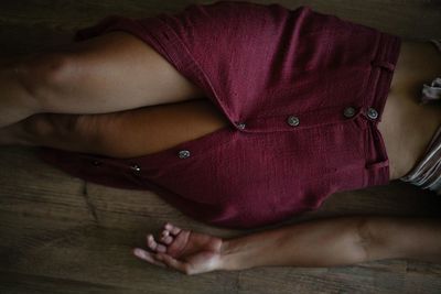 Midsection of woman lying on floor
