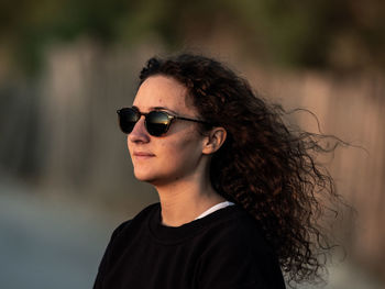 Young woman with long hair wearing sunglasses