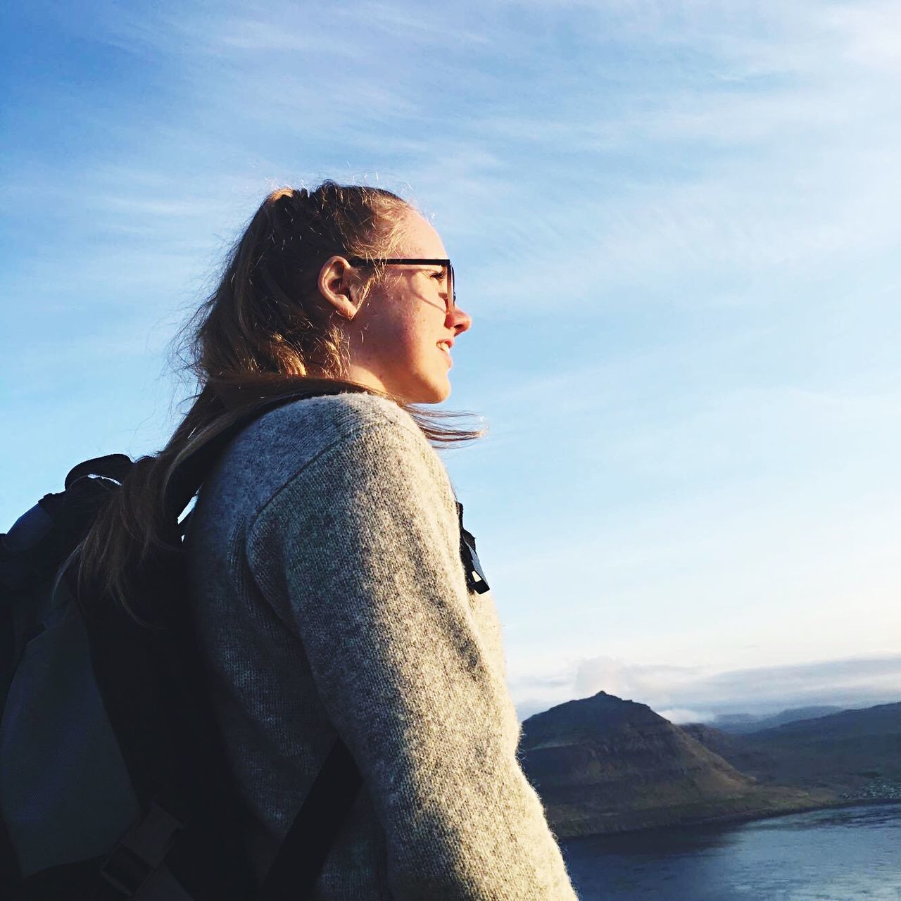 young adult, lifestyles, person, leisure activity, young women, sky, casual clothing, headshot, sunglasses, contemplation, side view, waist up, looking away, portrait, mid adult, mountain