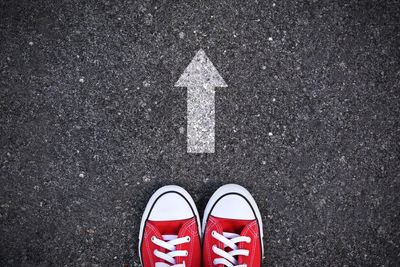 Low section of person standing on road