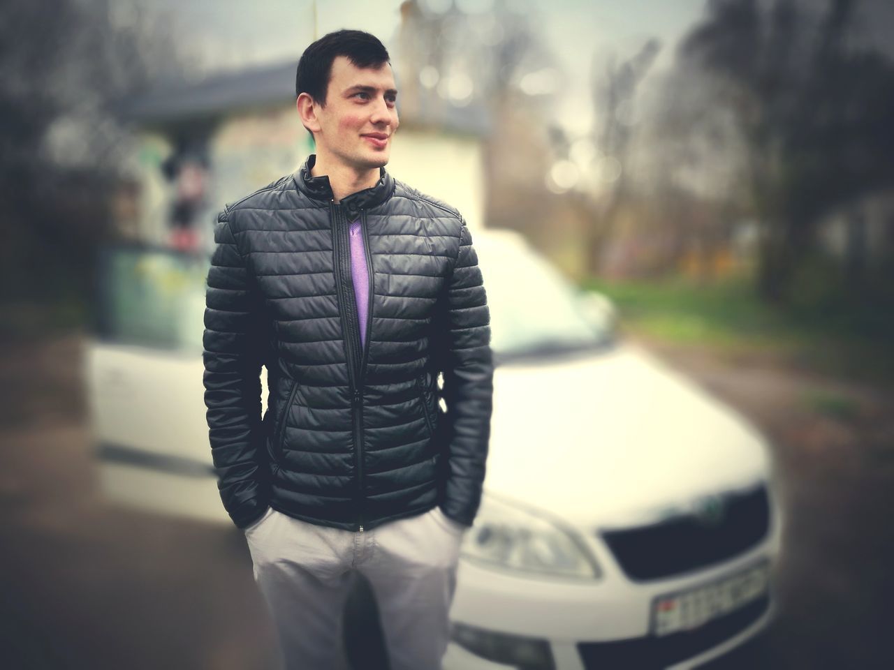 MAN STANDING ON CAR