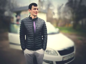 Full length of man standing in car