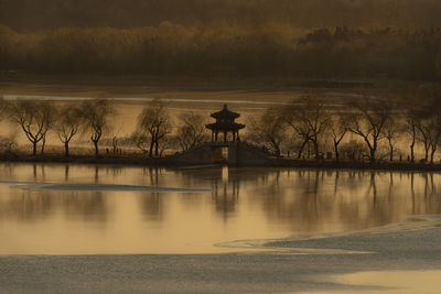 Scenic view of lake against sky during sunset