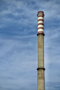 Low angle view of a power starion chimney against sky