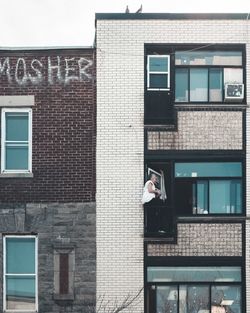 Man holding glass window of building