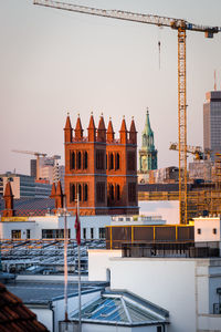 Buildings in city against clear sky