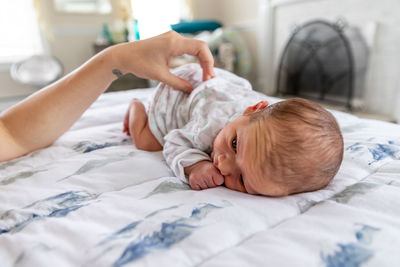 Cute baby lying on bed at home