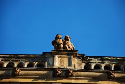 Low angle view of statue against clear blue sky