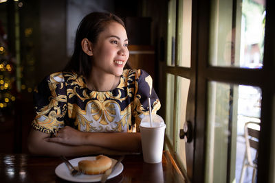 Portrait of smiling woman holding coffee cup