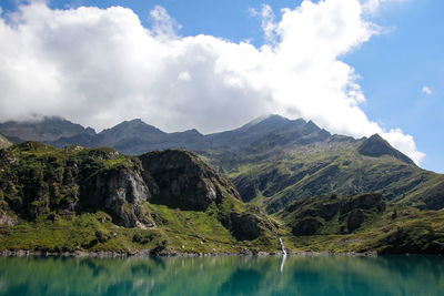 Scenic view of lake and mountains against sky