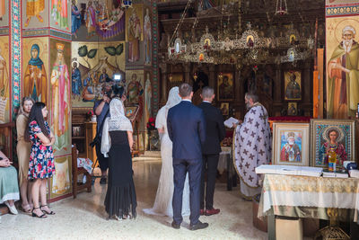 Group of people in temple outside building