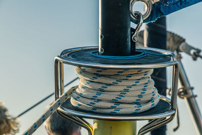 Close-up of rigging on sailboat against clear blue sky