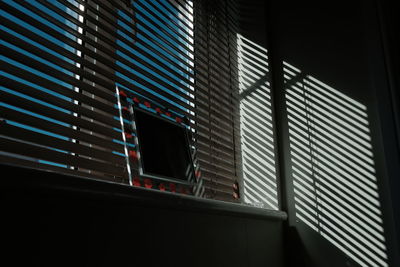 Low angle view of building seen through window