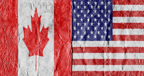 Full frame shot of canadian and american flags