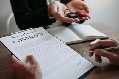 High angle view of couple holding hands on table