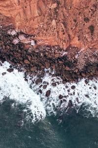 High angle view of rocks on sea