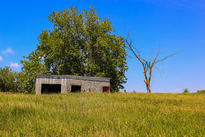 Built structure on field against sky