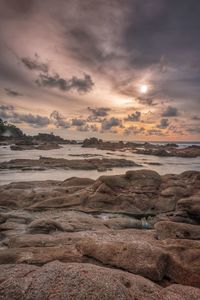 Scenic view of beach against sky during sunset