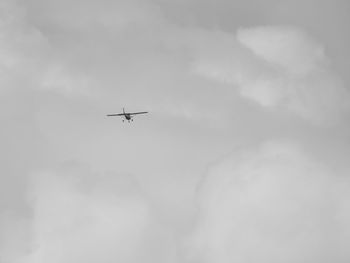 Low angle view of airplane flying in sky