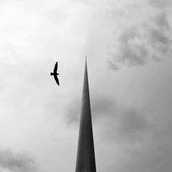 Low angle view of airplane flying against sky