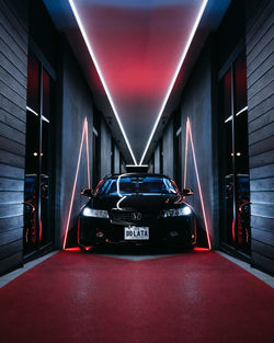 Illuminated car in city at night