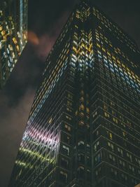 Low angle view of illuminated building against sky at night