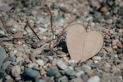 Close-up of heart shape stone on beach