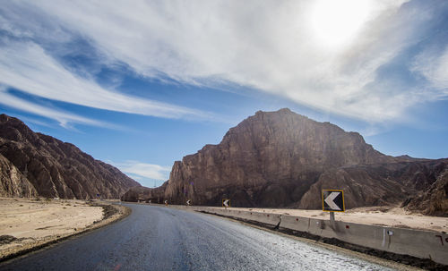 Road amidst mountains against sky