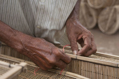 Midsection of man working in workshop