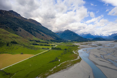 Scenic view of landscape and mountains against sky