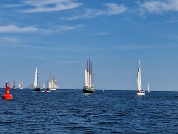 Sailboat sailing on sea against sky