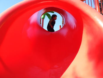 Close-up of people in red playground
