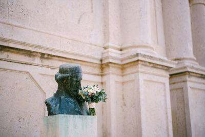 Low angle view of statue against historic building