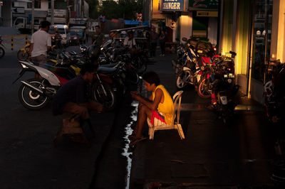 Side view of people walking on city street