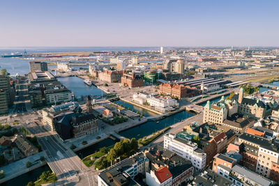 High angle view of city landscape by sea against sky