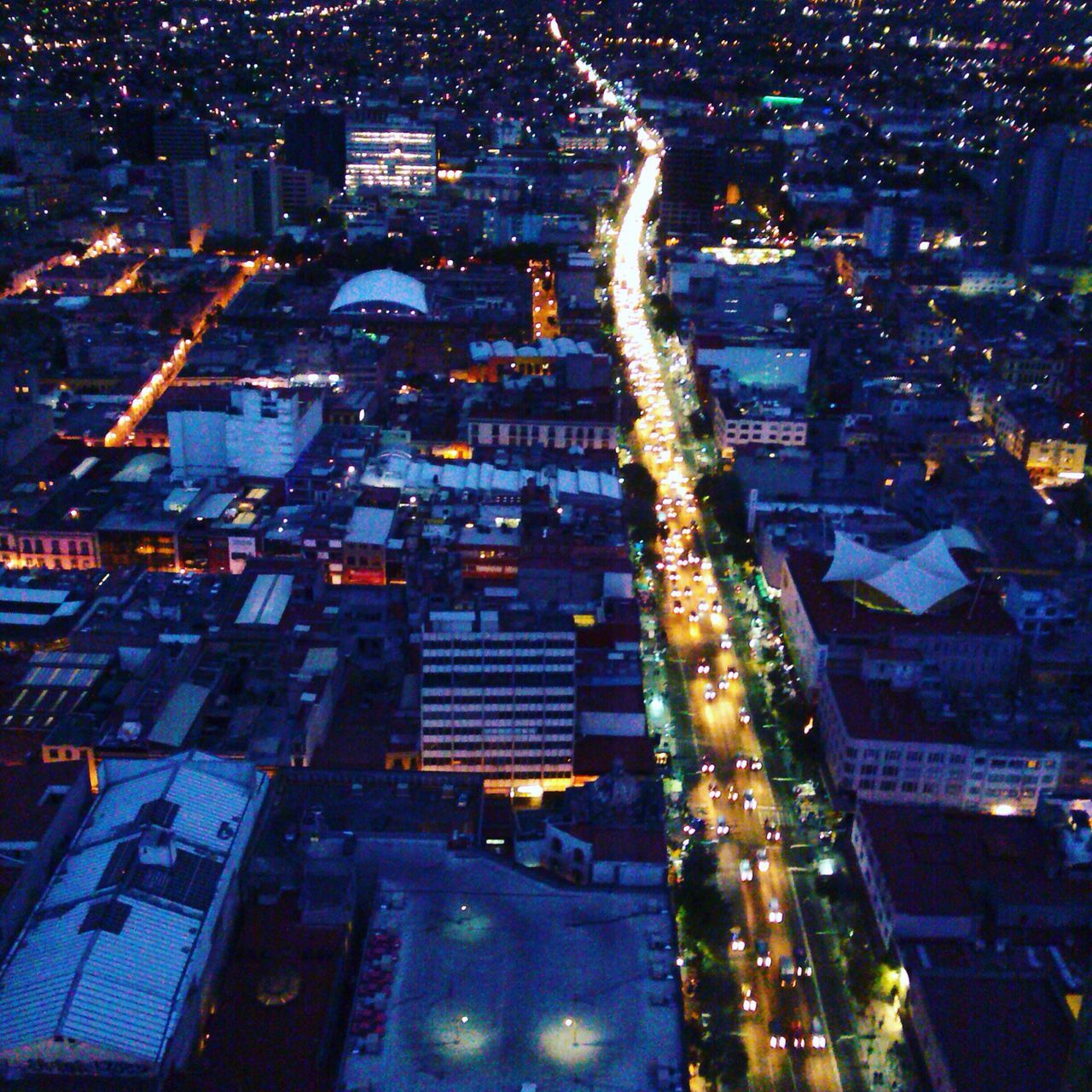 illuminated, night, city, building exterior, cityscape, architecture, built structure, crowded, high angle view, aerial view, residential district, city life, residential building, skyscraper, residential structure, capital cities, tall - high, tower, office building, light - natural phenomenon