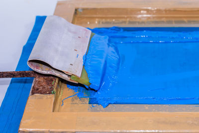 Close-up of blue paint on table