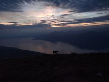 Scenic view of silhouette mountains against sky during sunset