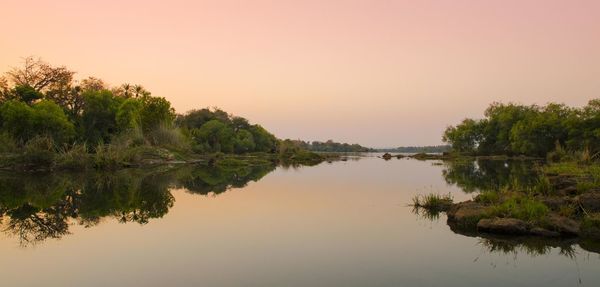 Scenic view of lake against sky during sunset