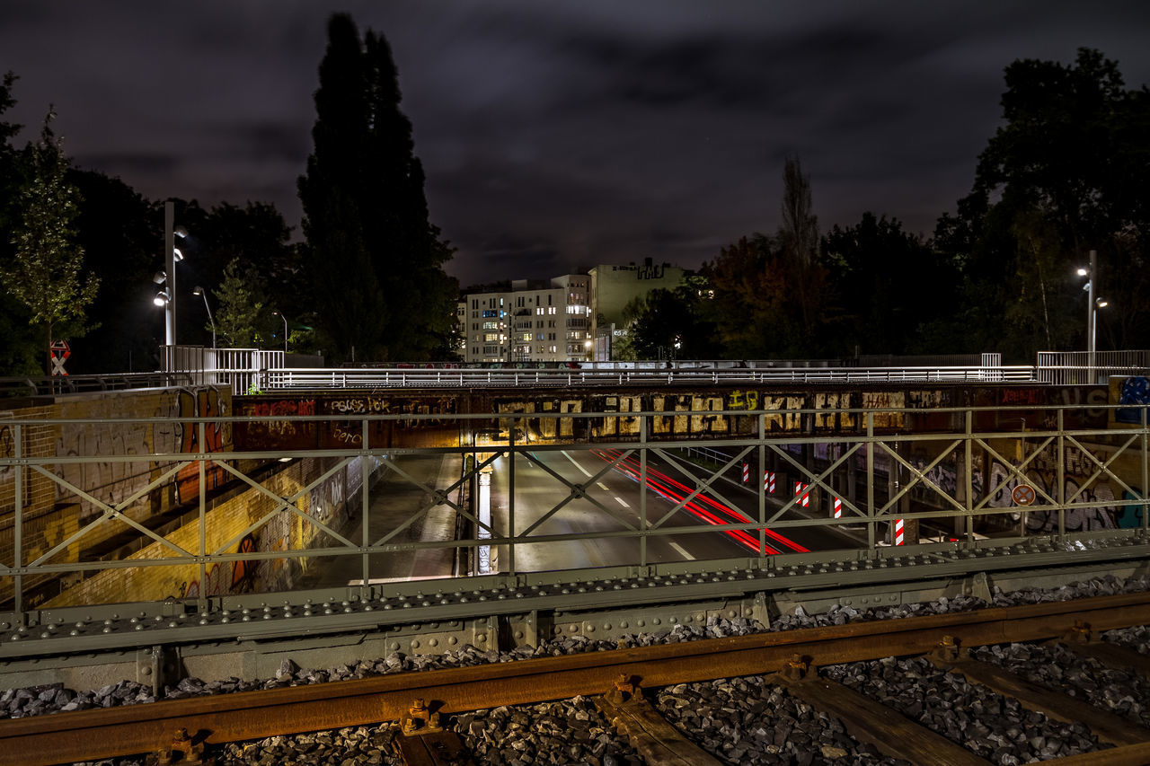 TRAIN ON RAILROAD TRACKS AGAINST SKY DURING SUNSET